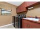 Laundry room with washer, dryer, and cabinets at 15658 Stuart Cir, Port Charlotte, FL 33981