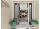 Elegant entryway with glass doors and a view into the living area at 15658 Stuart Cir, Port Charlotte, FL 33981