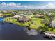 Aerial view showcasing a waterfront home and community at 15658 Stuart Cir, Port Charlotte, FL 33981