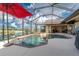 Inviting screened-in pool and spa with relaxing views at 15658 Stuart Cir, Port Charlotte, FL 33981