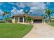 Beautiful home with a large driveway and lush landscaping at 15658 Stuart Cir, Port Charlotte, FL 33981