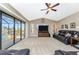 Gathering room with large TV, comfortable seating and sliding doors leading to a pool area at 15658 Stuart Cir, Port Charlotte, FL 33981