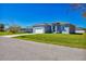 Newly built single story home with gray exterior and white garage at 308 Capatola St, Port Charlotte, FL 33948