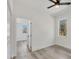 Bright bedroom with wood-look floors and an open door to another room at 308 Capatola St, Port Charlotte, FL 33948