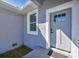 Gray front door with glass panels and black hardware at 308 Capatola St, Port Charlotte, FL 33948