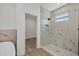 Bathroom with walk-in shower and marble tile at 308 Capatola St, Port Charlotte, FL 33948