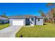 Newly built single-story home with gray exterior and white garage at 308 Capatola St, Port Charlotte, FL 33948
