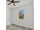 Spacious bedroom featuring a window with a view and ceiling fan at 308 Capatola St, Port Charlotte, FL 33948