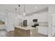 Modern kitchen with island, stainless steel appliances, and light wood cabinets at 308 Capatola St, Port Charlotte, FL 33948