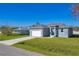 Newly built single story home with gray exterior and white garage at 308 Capatola St, Port Charlotte, FL 33948