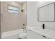 Clean bathroom with a bathtub, toilet, and vanity with a large mirror at 308 Capatola St, Port Charlotte, FL 33948