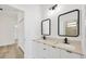 Modern bathroom with double vanity and black framed mirrors at 308 Capatola St, Port Charlotte, FL 33948