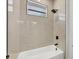 Clean bathroom with a bathtub and marble-style shower surround at 308 Capatola St, Port Charlotte, FL 33948