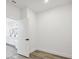 Bright bedroom with wood-look floors and an open door to the bathroom at 308 Capatola St, Port Charlotte, FL 33948