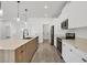 Modern kitchen with stainless steel appliances and light wood cabinets at 308 Capatola St, Port Charlotte, FL 33948