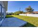 Large backyard with grassy area and concrete patio at 308 Capatola St, Port Charlotte, FL 33948
