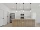 Modern kitchen with stainless steel appliances and light wood island at 308 Capatola St, Port Charlotte, FL 33948