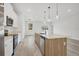 Modern kitchen with island, stainless steel appliances, and white cabinets at 308 Capatola St, Port Charlotte, FL 33948
