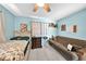 Light blue bedroom with a bed, dresser, and futon at 12325 Mitchell Ter, Port Charlotte, FL 33981