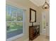 Bright entryway with decorative console table and mirror at 3113 Club Dr # 118, Port Charlotte, FL 33953