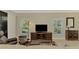 Living room featuring a large TV and ample natural light at 3113 Club Dr # 118, Port Charlotte, FL 33953