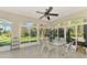 Bright sunroom with glass walls and seating area at 3113 Club Dr # 118, Port Charlotte, FL 33953