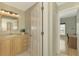 Bright bathroom with single vanity, linen closet, and view of office at 3113 Club Dr # 118, Port Charlotte, FL 33953