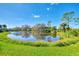 Serene pond view with reflection of homes and trees at 3113 Club Dr # 118, Port Charlotte, FL 33953