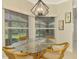 Bright breakfast nook with glass table and wicker chairs at 3113 Club Dr # 118, Port Charlotte, FL 33953