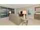 Bright living room with beige couch and access to a private patio at 3113 Club Dr # 118, Port Charlotte, FL 33953