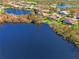 Aerial view of upscale homes surrounding a lake at 3487 Pennyroyal Rd., Port Charlotte, FL 33953