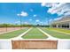 Outdoor bocce ball court with wooden bench at 3487 Pennyroyal Rd., Port Charlotte, FL 33953