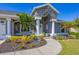 House exterior showcasing a gray house with stone accents, landscaping, and a walkway at 10083 Kansas City St, Port Charlotte, FL 33981