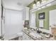 Bathroom with granite countertop, white cabinets and a shower/tub combo at 10083 Kansas City St, Port Charlotte, FL 33981