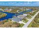 Aerial view of a waterfront property, showing a canal and surrounding houses at 10083 Kansas City St, Port Charlotte, FL 33981