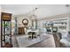 Elegant dining room with a round table, chandelier, and access to the pool at 10083 Kansas City St, Port Charlotte, FL 33981