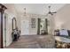 Living room featuring hardwood floors, a ceiling fan, and a comfortable sitting area at 10083 Kansas City St, Port Charlotte, FL 33981