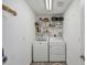 Bright laundry room with washer, dryer, and ample shelving at 10083 Kansas City St, Port Charlotte, FL 33981