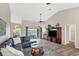 Open living room showcasing a sectional sofa, hardwood floors, and pool access at 10083 Kansas City St, Port Charlotte, FL 33981