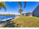 Landscaped backyard with private dock and canal views at 10083 Kansas City St, Port Charlotte, FL 33981