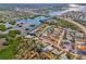 Aerial view of a waterfront community with docks, homes, and lush greenery at 105 Crestview Dr, Englewood, FL 34223