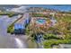 Aerial view of a waterfront community with a pool, tennis court, and docks at 105 Crestview Dr, Englewood, FL 34223