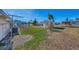 Backyard with a storage shed, grass lawn, and gravel landscaping at 105 Crestview Dr, Englewood, FL 34223