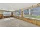 Bright Florida room with jalousie windows, wood paneling, and concrete floor at 105 Crestview Dr, Englewood, FL 34223