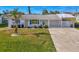 Elevated perspective of the home's front yard, showcasing the landscaping and driveway at 105 Crestview Dr, Englewood, FL 34223