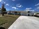 Front view of home with driveway, attached carport and green lawn at 105 Crestview Dr, Englewood, FL 34223