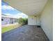 Covered patio with paver stones and exterior access to a storage room at 13512 Isabell Ave, Port Charlotte, FL 33981