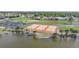 Aerial view of community tennis courts near a lake at 13512 Isabell Ave, Port Charlotte, FL 33981