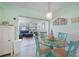 Charming dining area with glass table and turquoise chairs at 13512 Isabell Ave, Port Charlotte, FL 33981