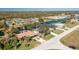 Aerial view of home on canal with lush landscaping, showcasing surrounding community at 217 Rotonda Cir, Rotonda West, FL 33947
